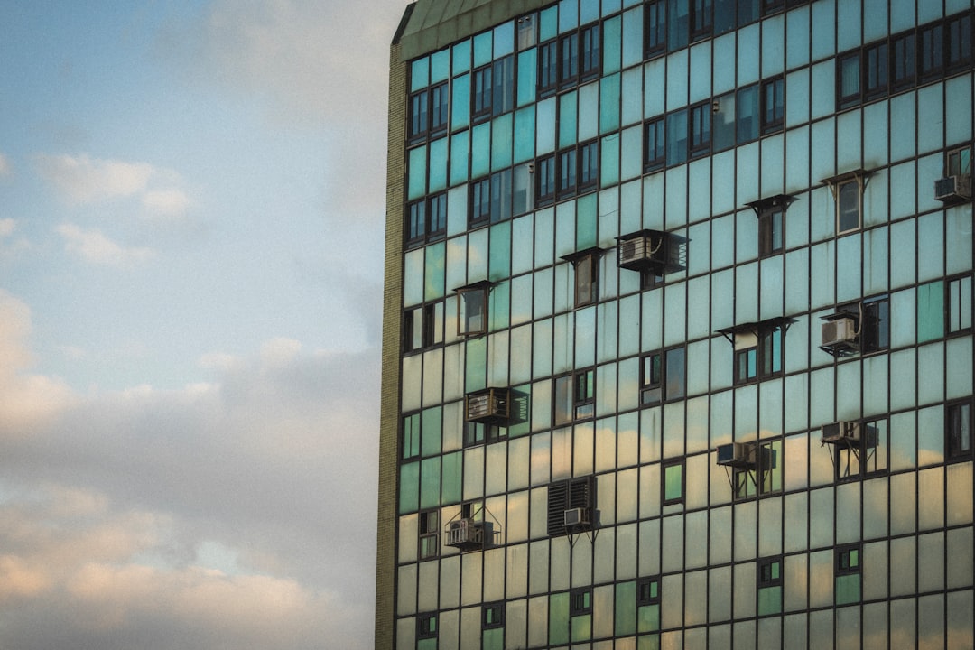 Building exterior with air conditioning units mounted below windows
