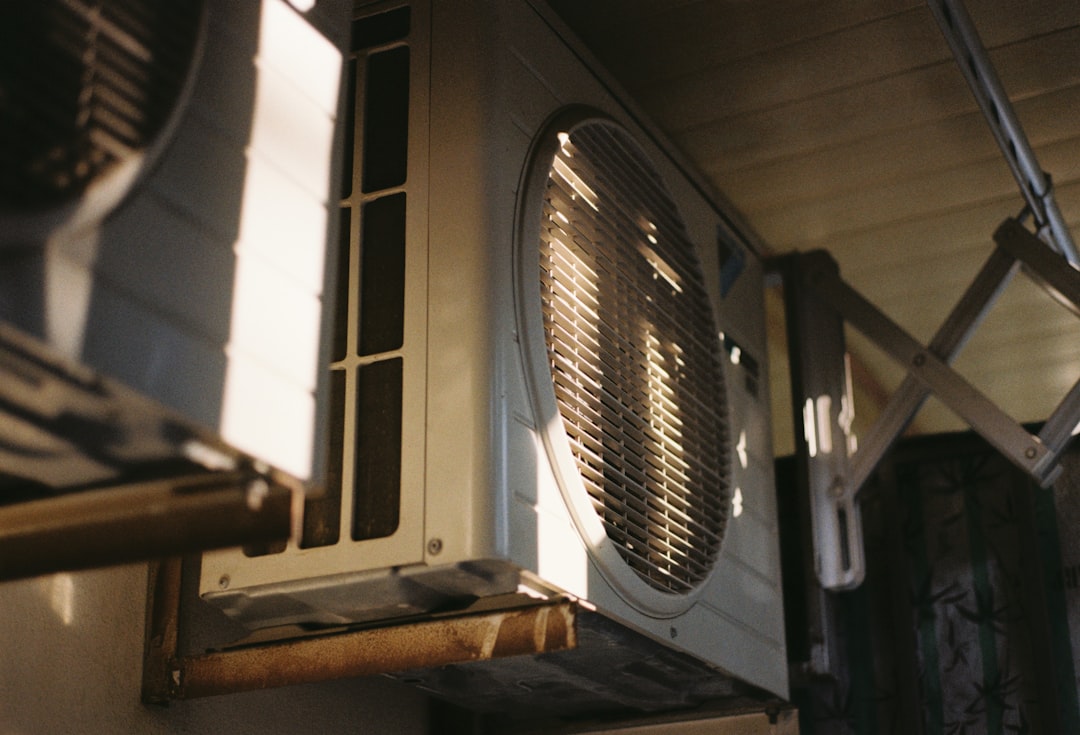 Close-up of an outdoor air conditioning compressor unit on a sunny day